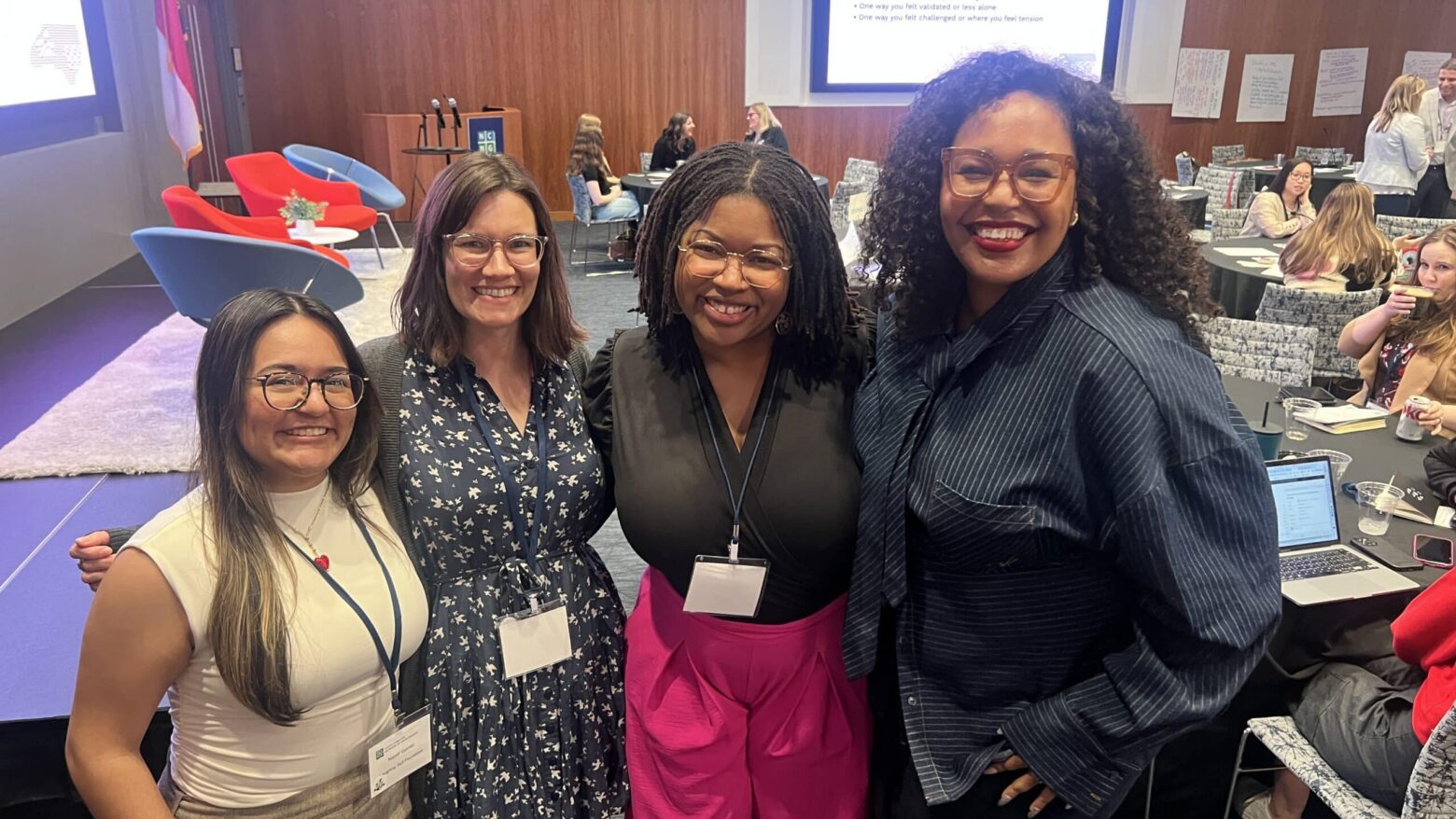 group of four staff members at a conference event